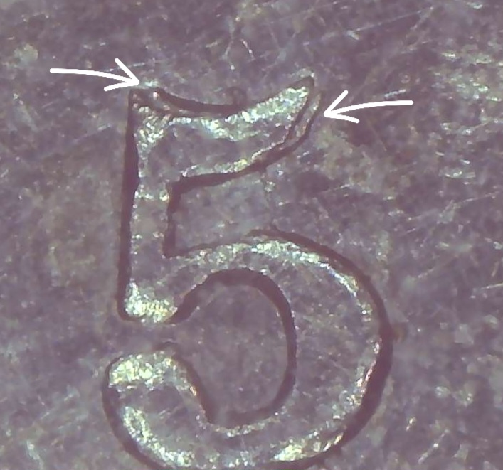 Authentic close-up of the repunched 5 (5/5) on an 1858 Canadian five-cent coin, with arrows indicating punch remnants