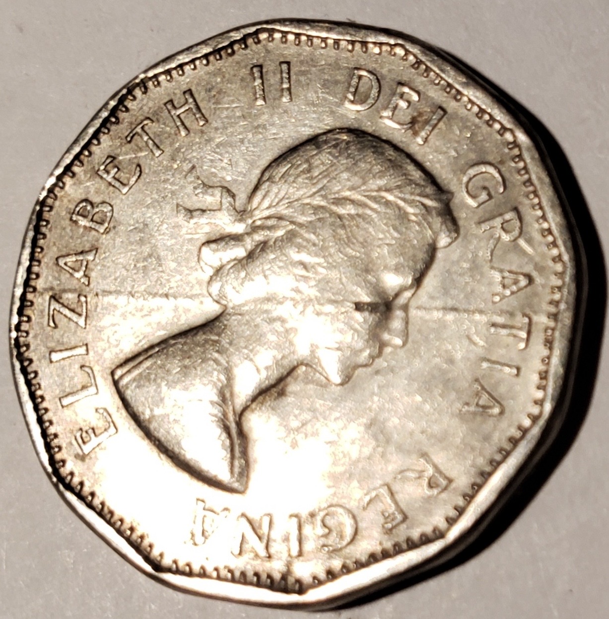 Canadian nickel showing a planchet or plating defect with plating separating near the rim