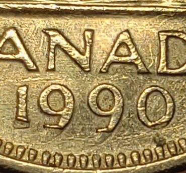 Close-up of the date on a 1990 Canadian coin altered by coin rolling machine damage