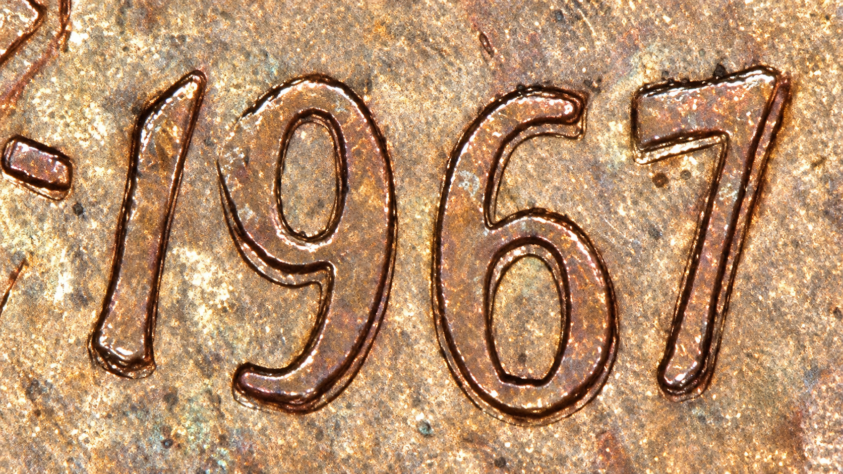 Magnified 1967 Canadian cent date showing visible secondary outlines on the numerals
