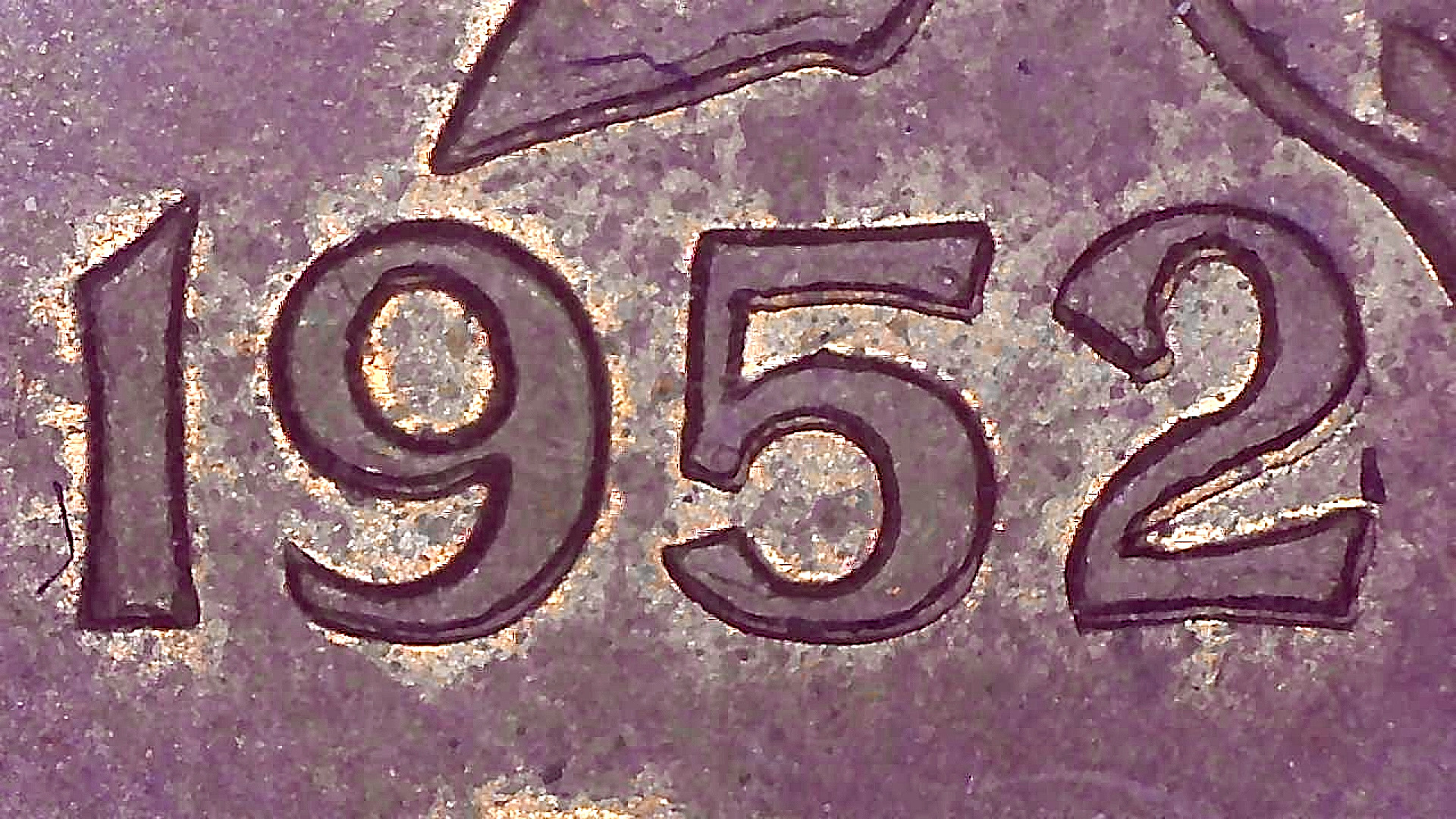 Authentic 1952 Canadian coin date showing secondary outlines and thickening around numerals
