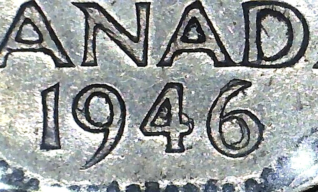 Authentic 1946 Canadian coin date with irregular thickening and rough outlines around the lettering and numerals