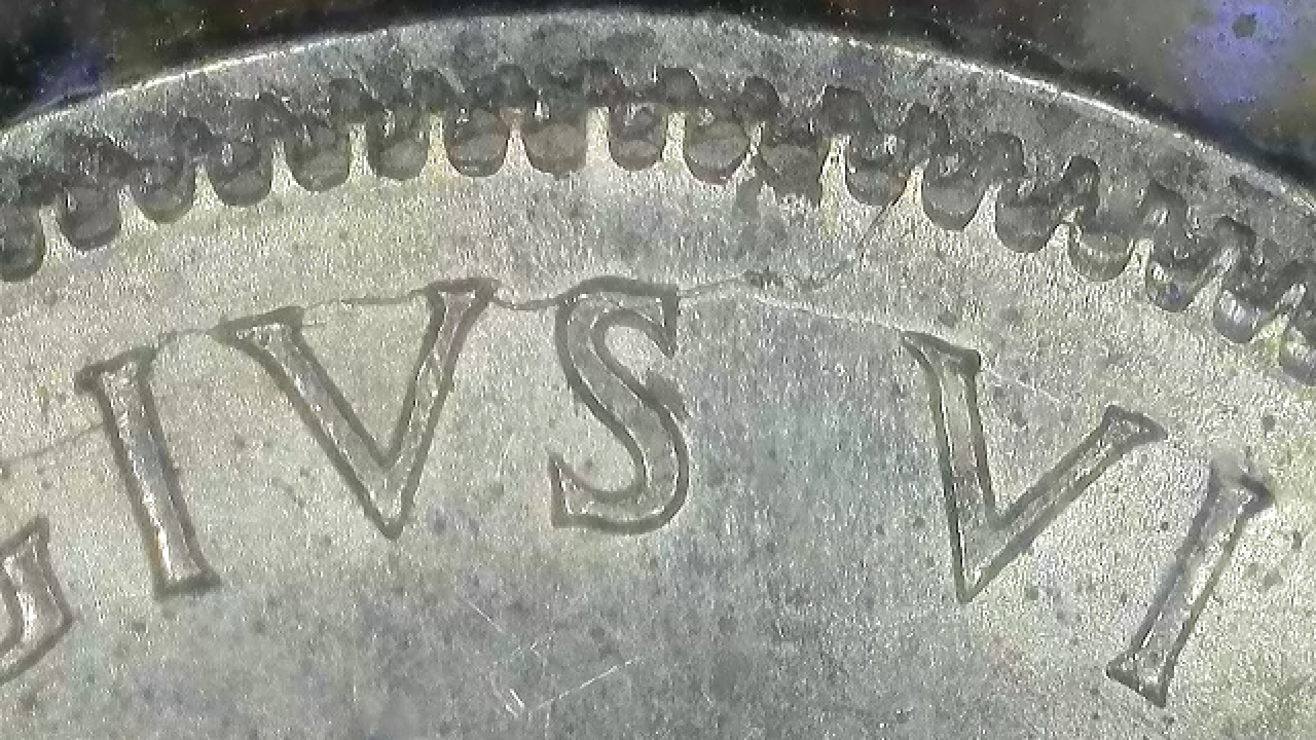1942 Canadian ten-cent coin showing a die crack near the letter S extending toward the denticles