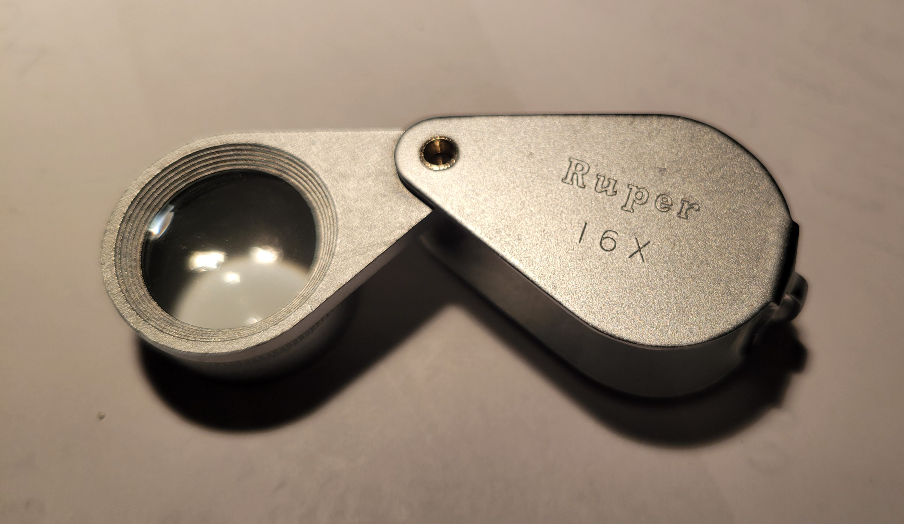 Japanese Ruper 16x achromatic loupe used for coin examination